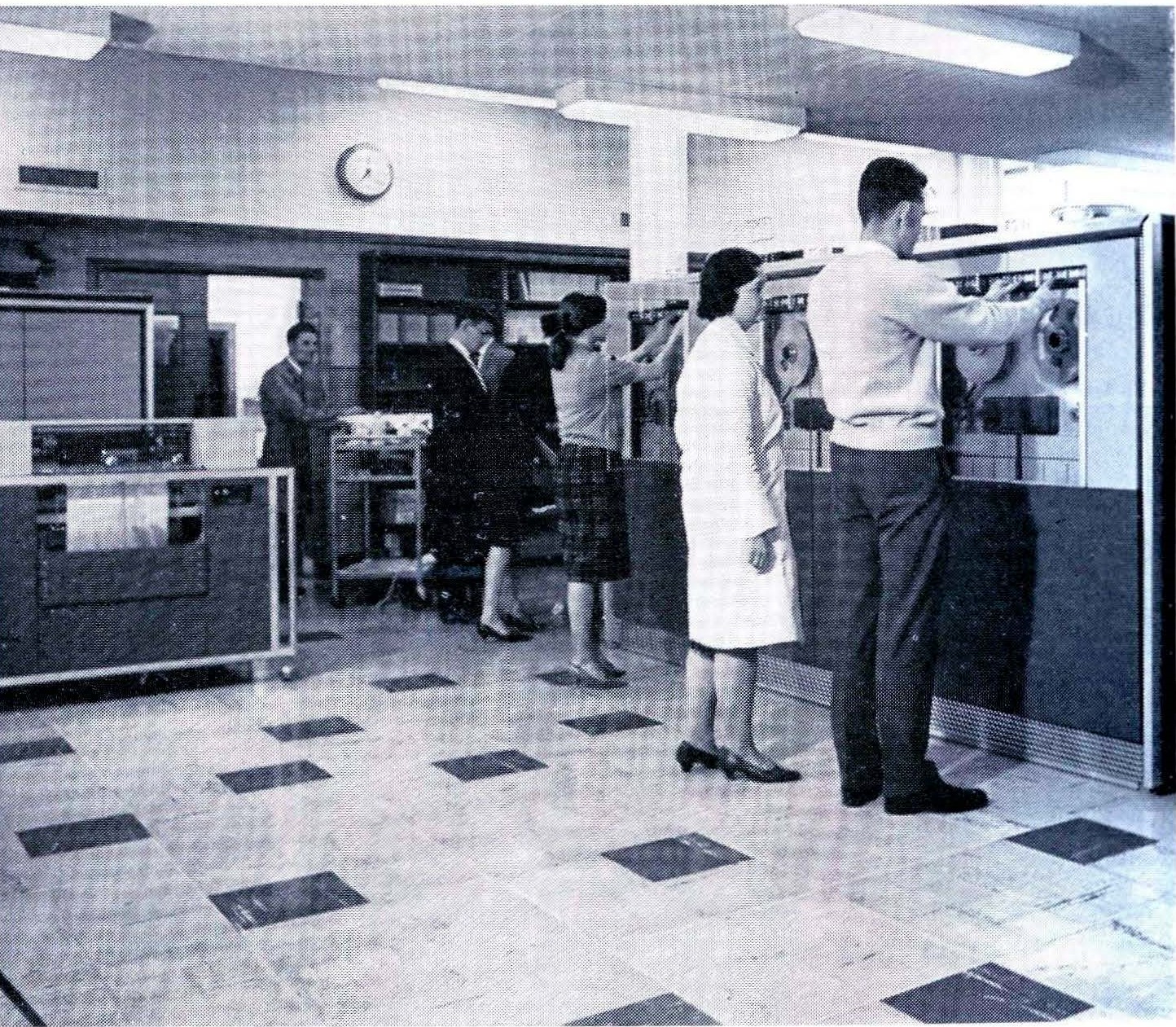 Photograph of operators working at the magnetic tape units in the Basser Computing Department