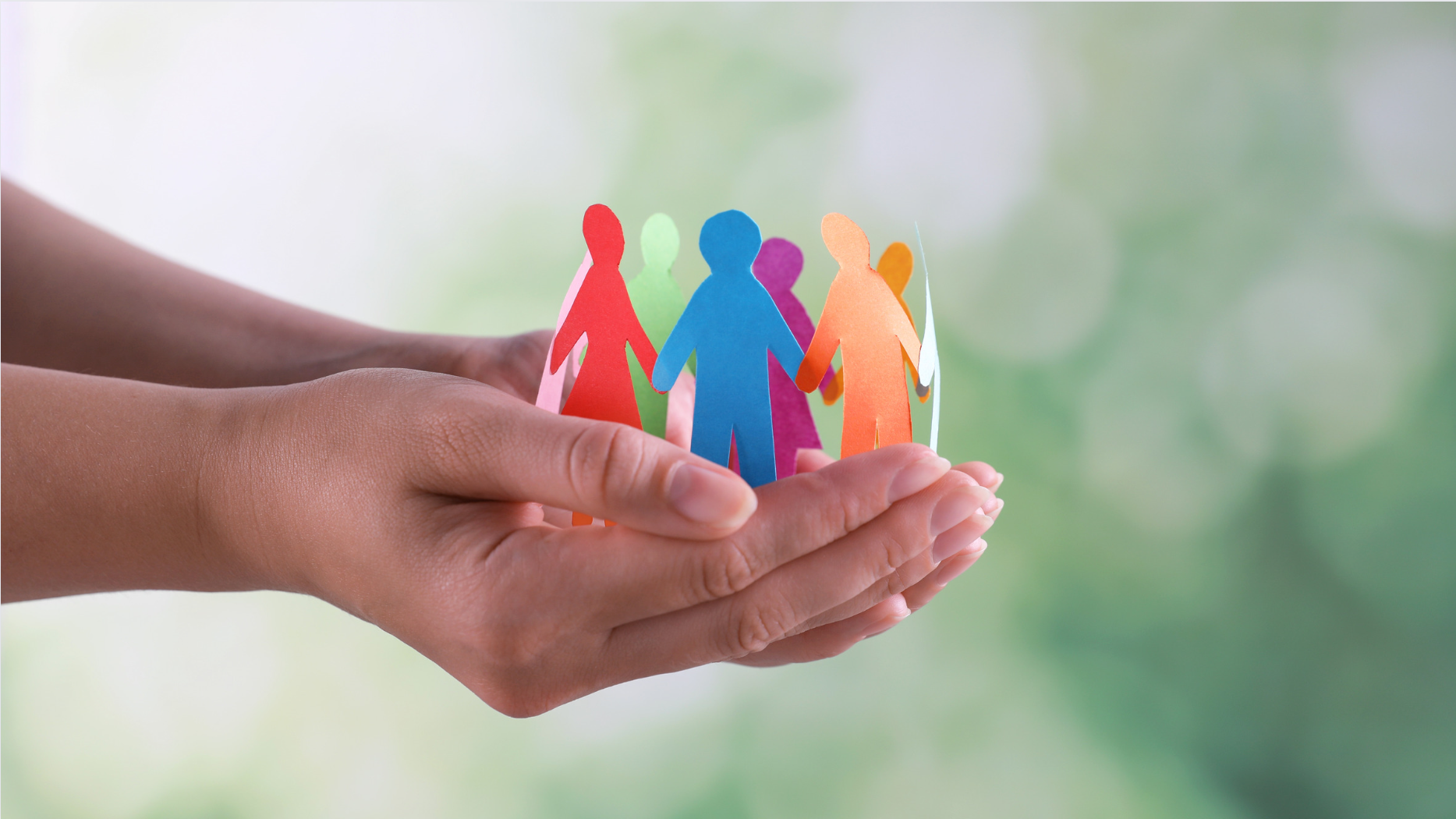 Hands holding colourful paper people