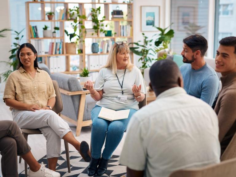 Group of people sitting in a circle talking