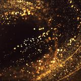 Abstract swirl of glitter gold on dark background