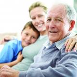 Elderly man with a young woman and child