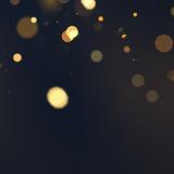 Beautiful golden glitter stars on abstract black background