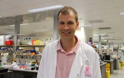 Kirill Alexandrov in a lab coat facing the camera