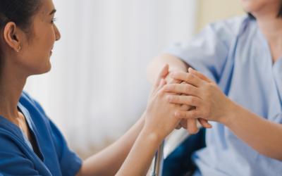 Nurse holding hands with patient