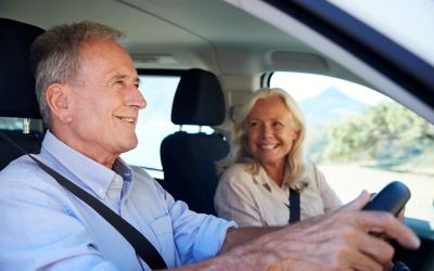 Elderly couple driving in a car together