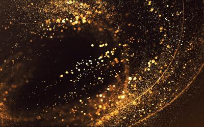 Abstract swirl of glitter gold on dark background