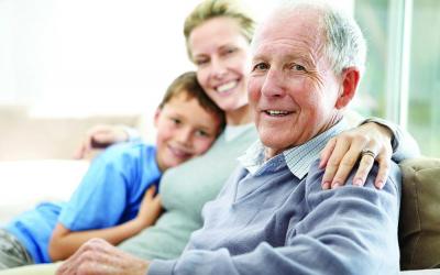 Elderly man with a young woman and child