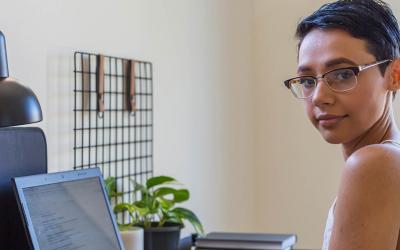 Person with glasses using a comptuer 