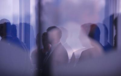 Image of people dressed in corporate wear gathered in city building